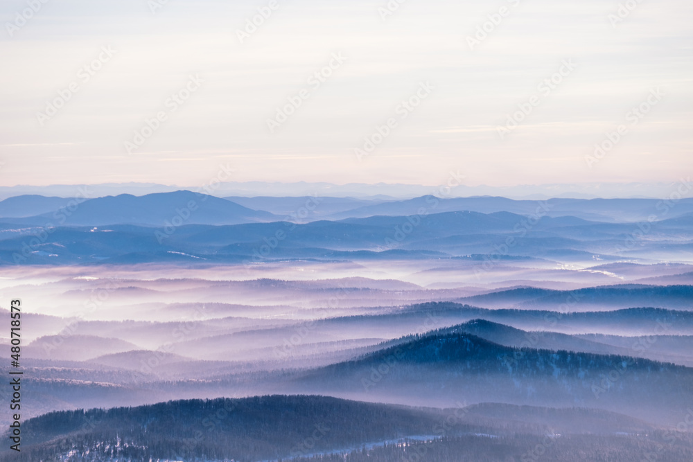 Russia. Sheregesh. Low fog, clouds among the mountains. Photography in purple tones