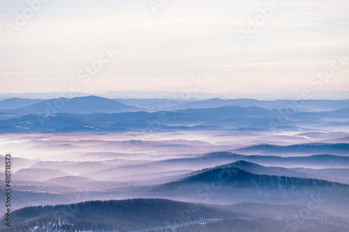Russia. Sheregesh. Low fog, clouds among the mountains. Photography in purple tones