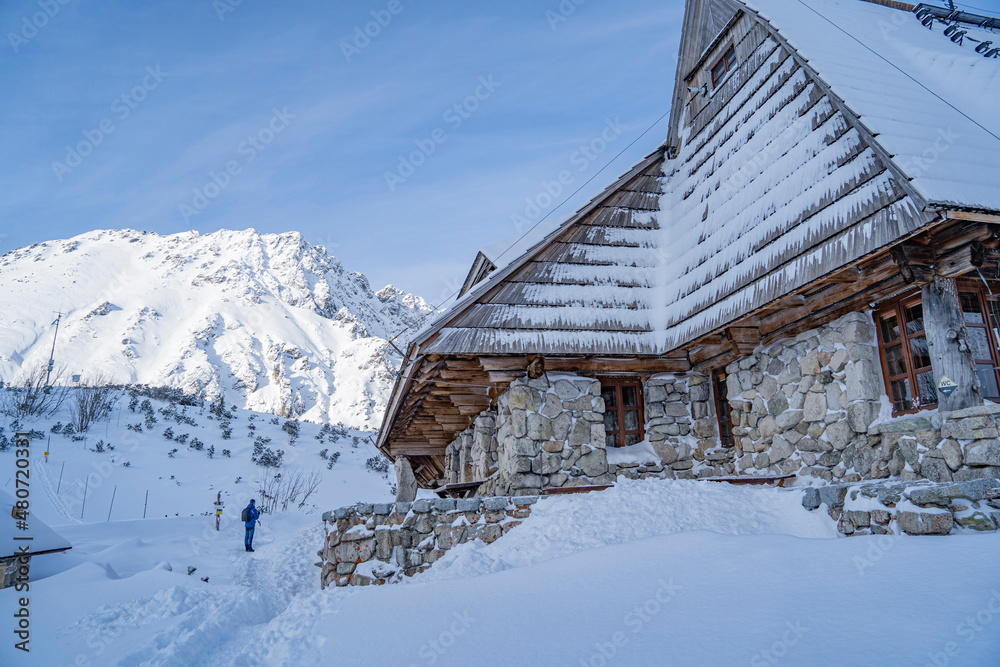 Fototapeta premium house for tourists in the Tatra Mountains in the middle of high mountains in the snow in winter Poland