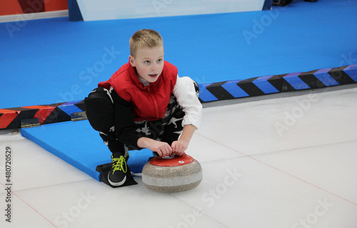 Obraz na płótnie boy playing curling in a sports club
