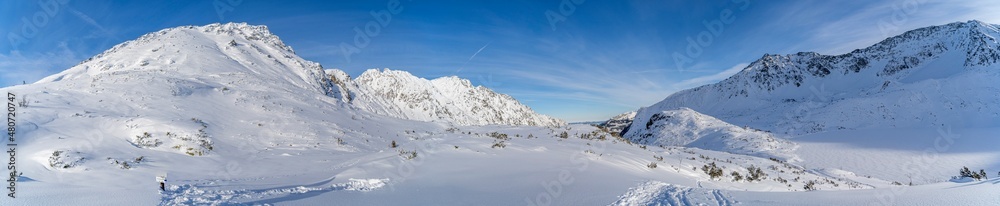 panorama of the Tatra Mountains, winter mountain landscape in the Tatras, mountain view covered with snow in frosty sunny weather