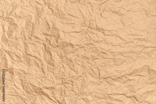 Obraz na płótnie Crumpled brown kraft paper background. Abstract texture for design. Copy space for ad or announcement. Top view. w salonie