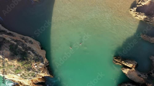 Aerial view of beautiful Portuguese beaches with rocky sandy shores and pure sand for tourists' recreation in the Algarve in the south.