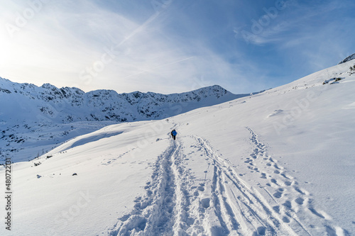 Fototapeta Naklejka Na Ścianę i Meble -  Mountain winter landscape in the Tatras, trail trampled in the snow overlooking the snow-capped mountains in frosty sunny weather Tatras Poland