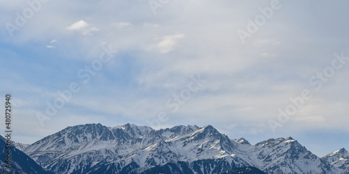 Panoramic morning shot of snow-covered peaks of the Tien Shan mountain ranges, Kazakhstan