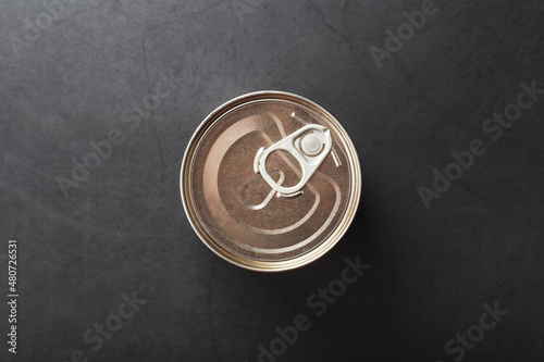 A can with a metal lid and a ring for opening