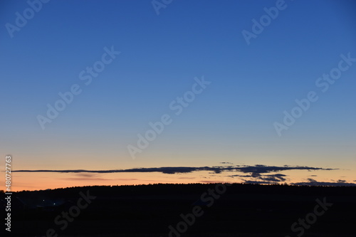Evening moonlit rural landscape with blue sky