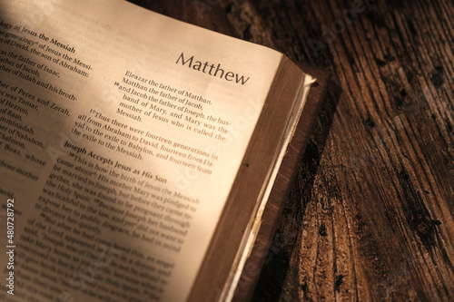 open bible on wooden table, chapter Matthew. contrast atmosphere photo
