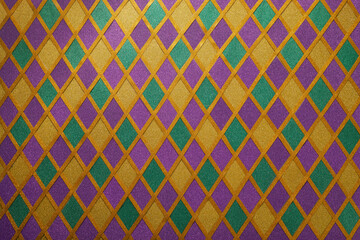 Shiny green, purple and golden glittering paillettes diamonds fabric. Mardi Gras holiday background.