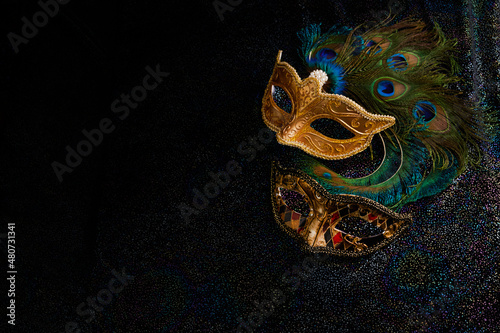 Luxury venetian mask on dark glitter background. Carnival masquerade fantasy mask
