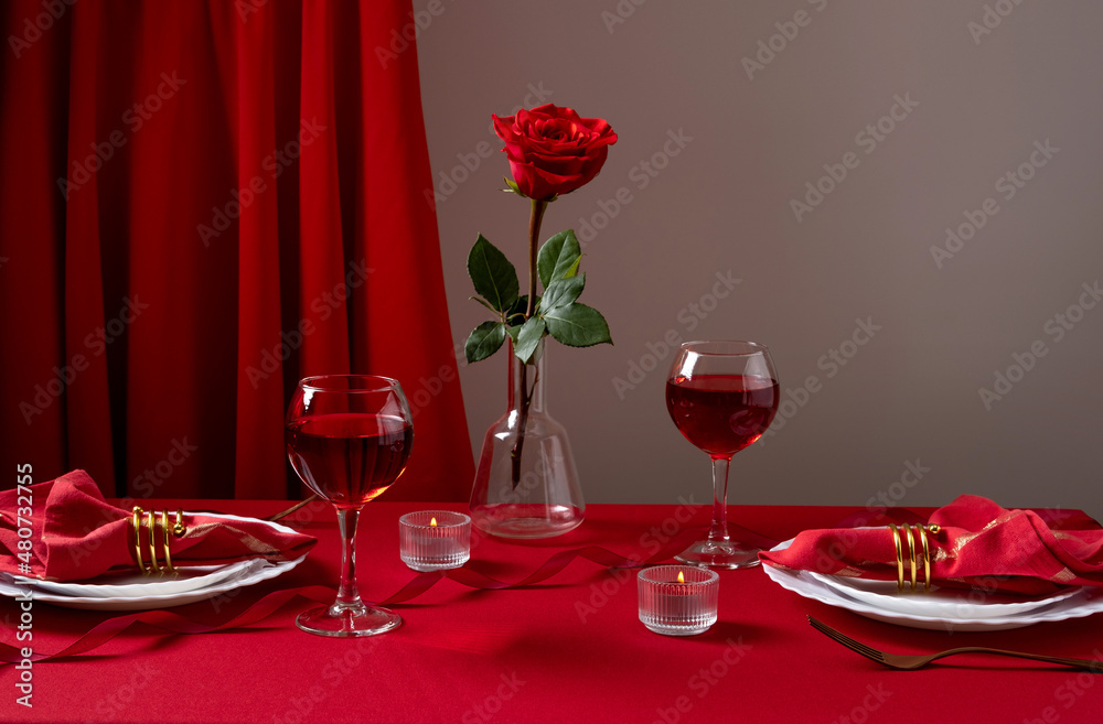 Romantic table setting with white dinnerware and red napkins, wine and candles. Valentines day or romantic dinner concept. Romantic Dinner. Romantic table setting with white dinnerware and red napkins, wine and candles. Valentines day or romantic dinner concept. Romantic Dinner.