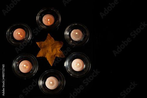 Burning candle on black background. Holocaust memory day photo