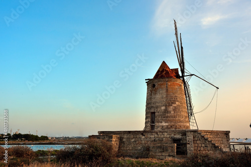 The salt flats with a windmill of Trapani, Sicily (Italy)
