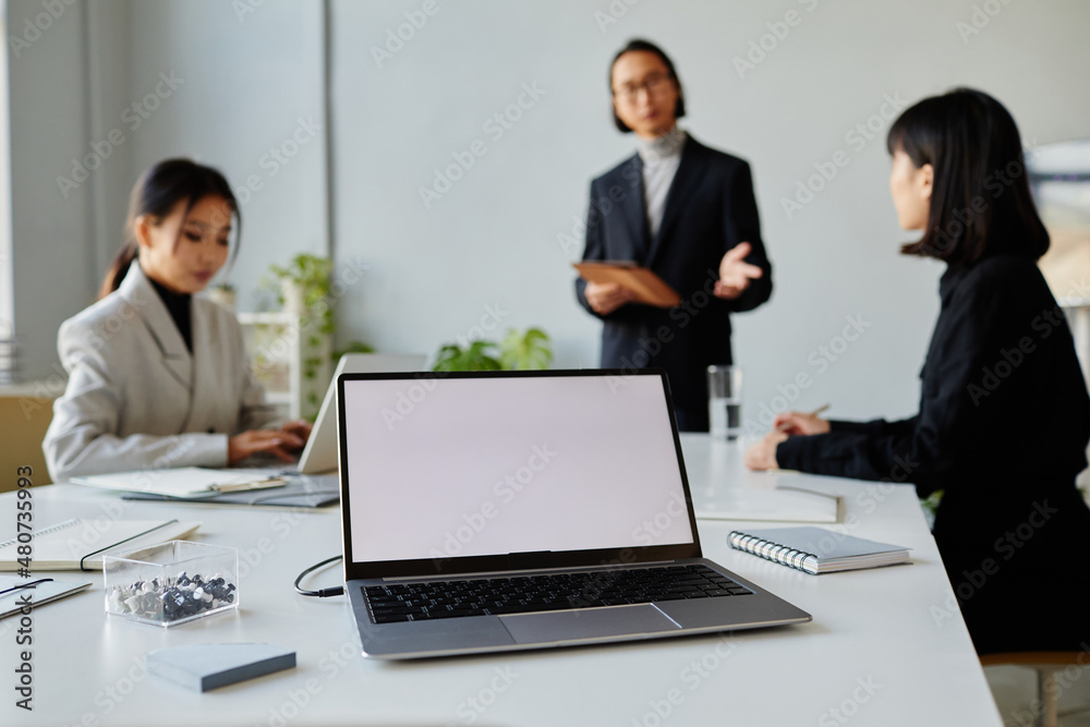 Background image of white laptop screen at meeting table in conference room, copy space Background image of white laptop screen at meeting table in conference room, copy space