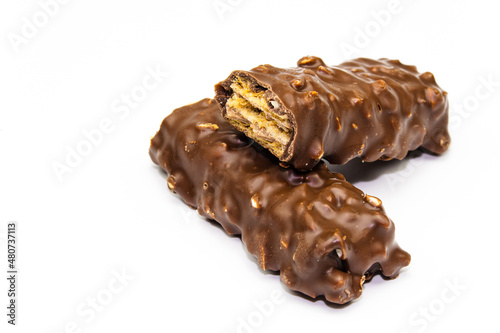 Wafers, cookies and sweets concept with hazelnut and chocolate. Cracked chocolate bar with snack wafers.