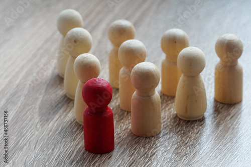 leadership concept. Wooden dolls in triangle concept