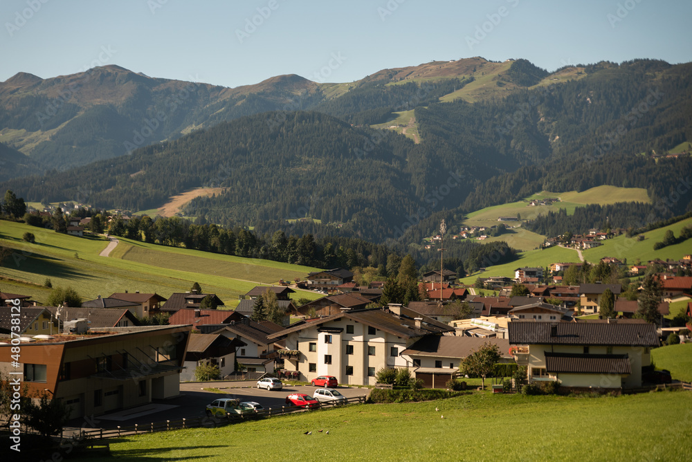 Beautiful alpine landscape with green meadows, alpine cottages and mountain peaks,  Austria
