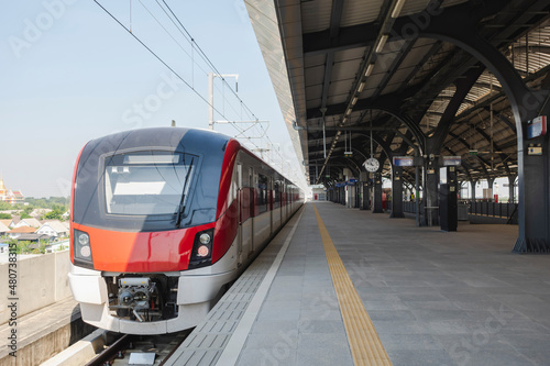 high-speed train is parked in the station waiting to pick up passengers