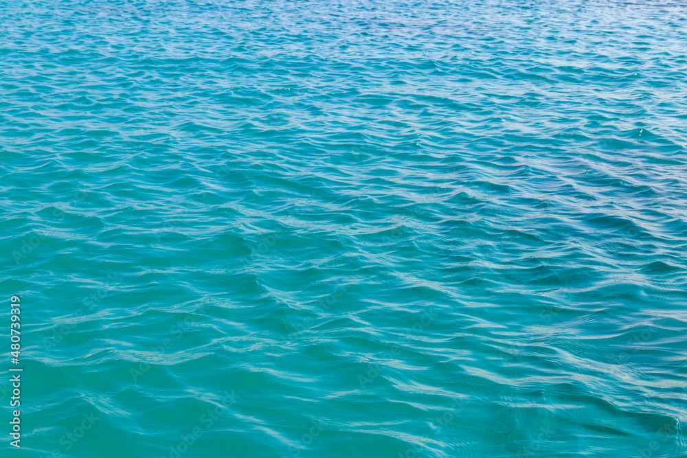 Blue water texture background. Surface of sea or ocean