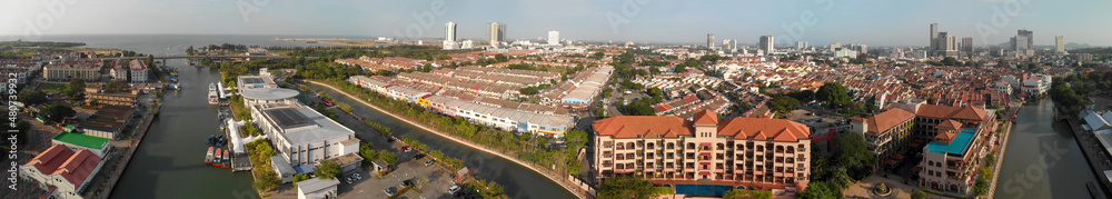 Malacca, Malaysia. Panoramic aerial view of city skyline and river from drone on a hot sunny day