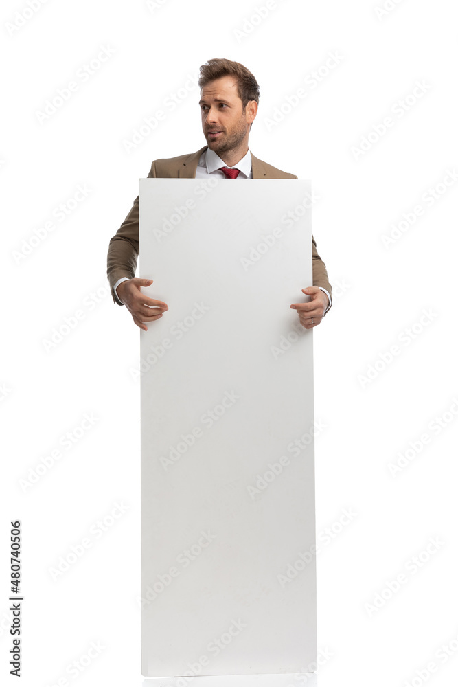 businessman holding his vertical board and looking to the side businessman holding his vertical board and looking to the side