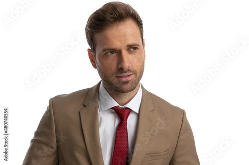 young businessman looking away, wearing a nice suit