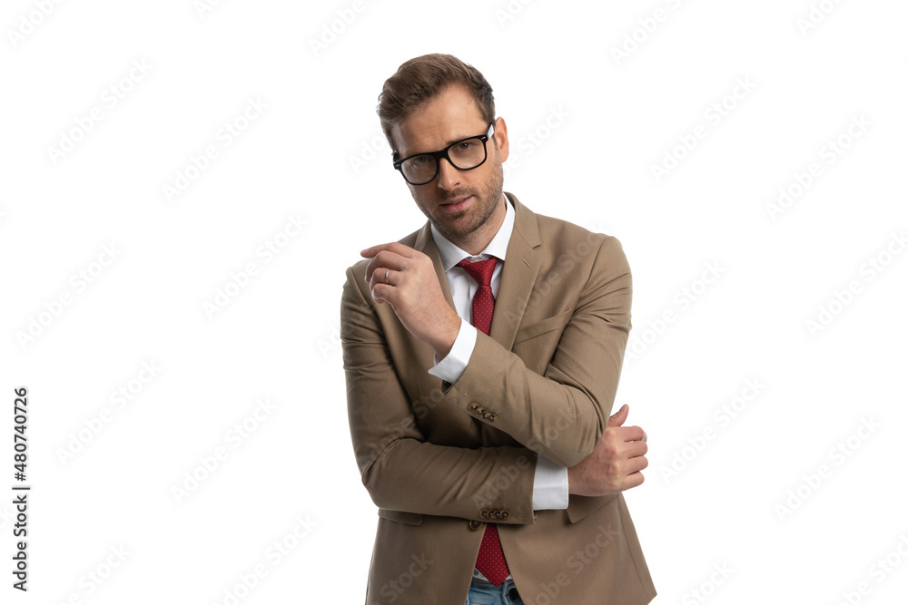 young businessman sensually folding his arms and wearing eyeglasses young businessman sensually folding his arms and wearing eyeglasses
