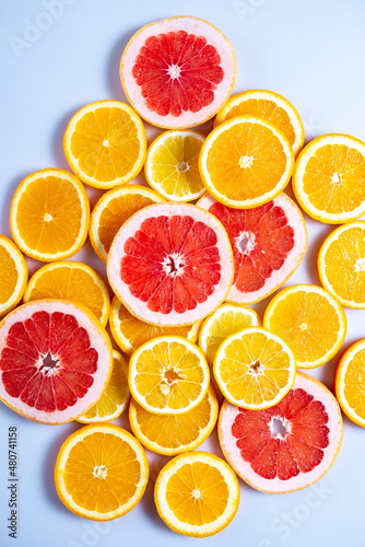 Slises of different citruses on the white background. Close-up of slised citruses.
