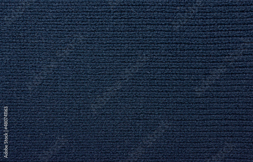 The texture of a beautiful knitted fabric. The pattern is clearly visible.