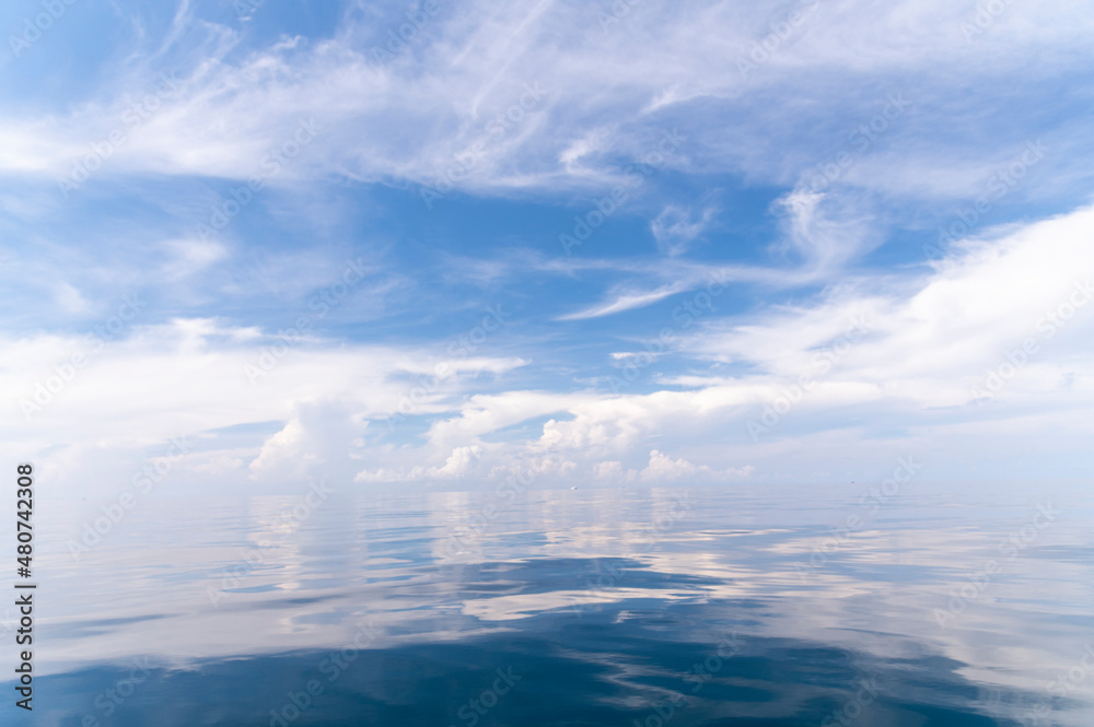 Blue sky and white fluffy clouds with reflect on sea background and pattern