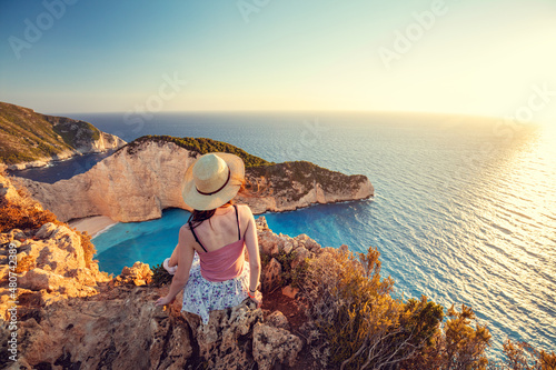 Woman tourist in Zakynthos, Greece admiring the Navagio beach