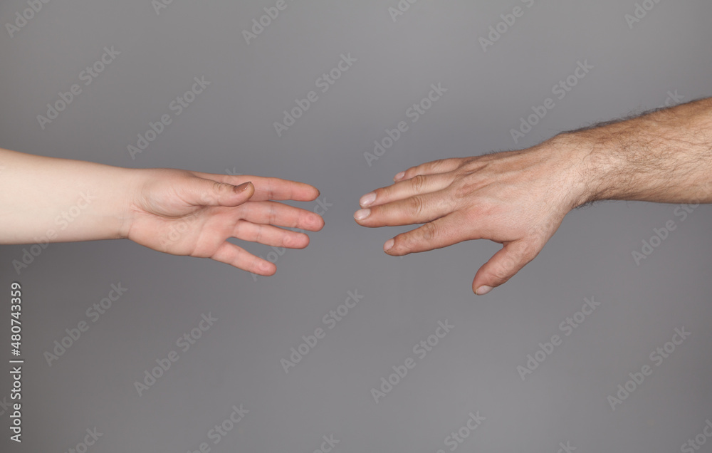 Hands of man and woman holding together, Gray background. Hands of man and woman holding together, Gray background.