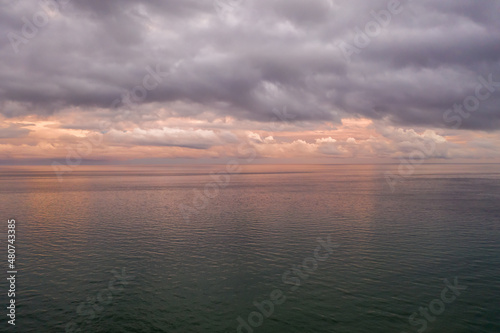 aerial foto of dramatic morning sky  glowing clouds over calm open water