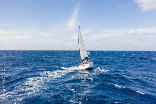 Sailing vessel on open water under clear skies in the atlantic ocean