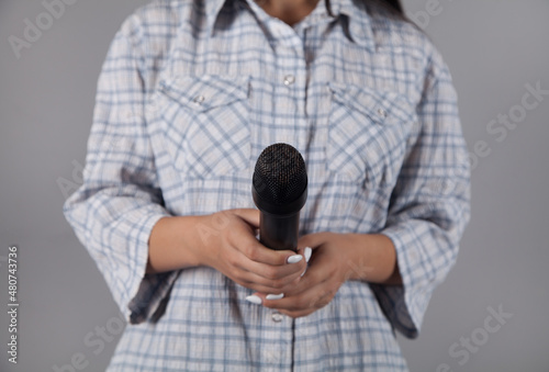 Person woman with a microphone.