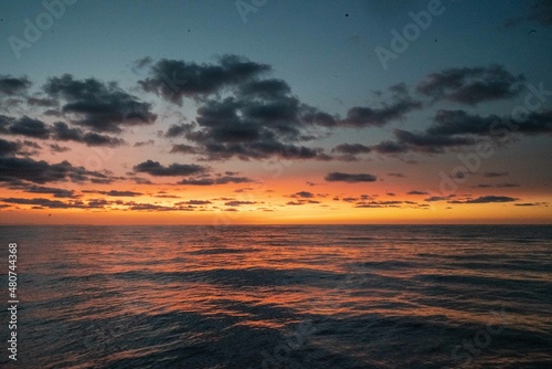 Fototapeta Naklejka Na Ścianę i Meble -  Calm golden sunset on open water while sailing the atlantic ocean