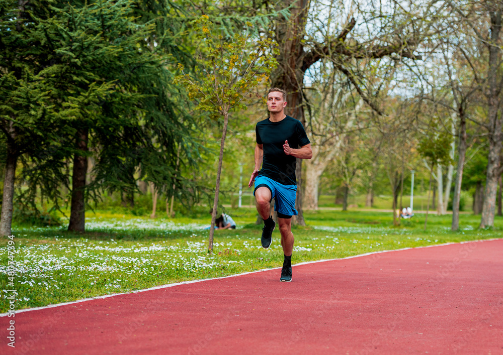 Male athlete in sprint run wearing sports running shoes and shorts in workout for marathon Male athlete in sprint run wearing sports running shoes and shorts in workout for marathon