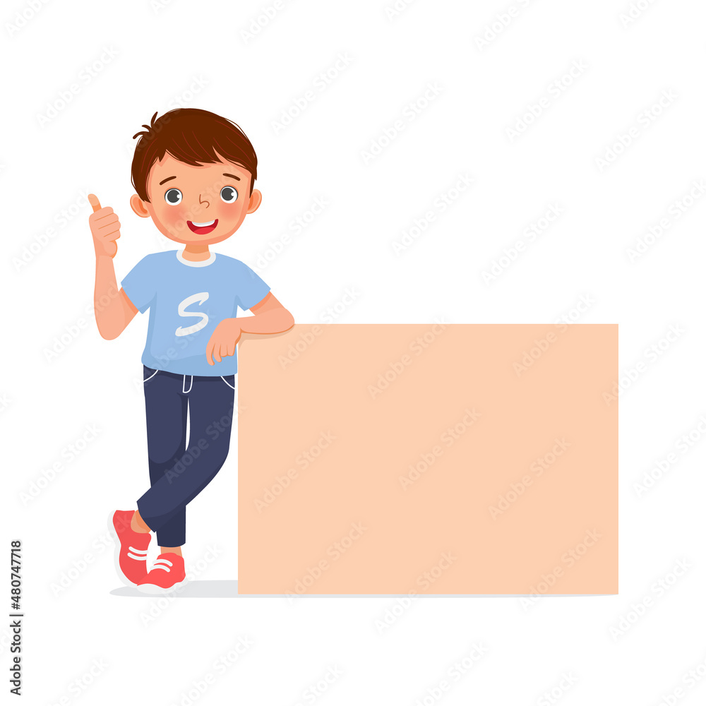 happy little boy leaning on empty poster or signboard showing thumb up gesture
