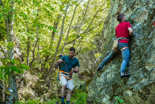 People are rock climbing in nature