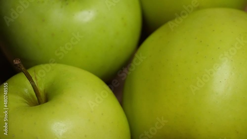 Four green apples, macro video. Apples of the Reinette Simirenko variety.
 photo