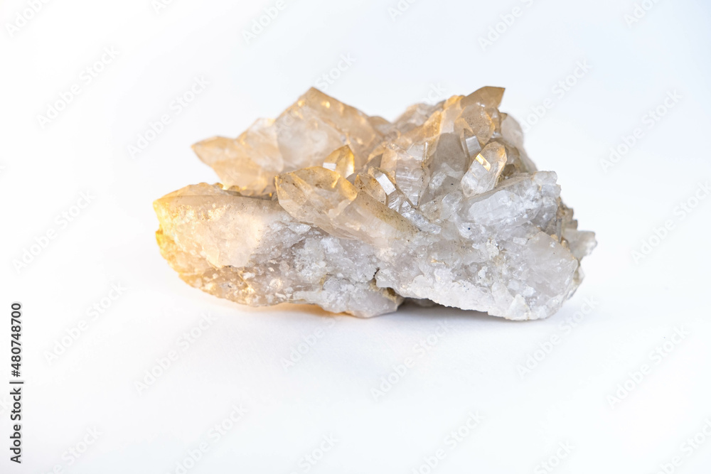 a close-up sample of a natural mineral from the geological collection is unpolished druse rock crystal isolated on a white background. a close-up sample of a natural mineral from the geological collection is unpolished druse rock crystal isolated on a white background.