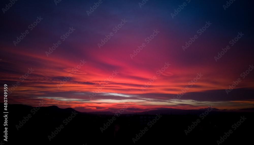 Red and pink sky background. Beautiful sky with clouds in pink and red background