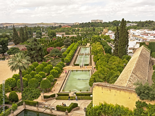 Gardens with water pools, orange and cypress trees and boxwood of the Alcazar de los Reyes Cristianos in Cordoba, Andalusia, Spain. photo