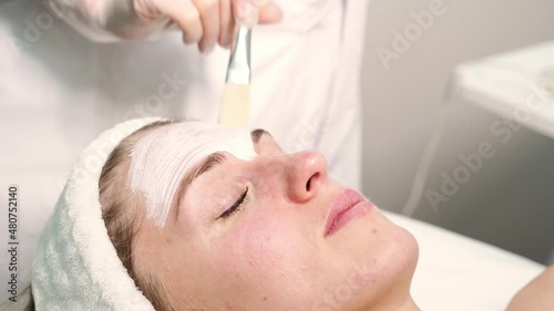 Portrait of moisturizing clay mask for medical design. Woman skin procedure. Natural cosmetic products. Beauty face. Facial cosmetology treatment. Healthcare peeling cream video