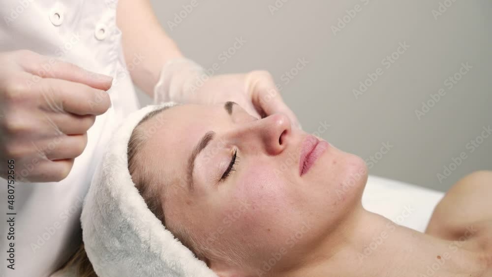 Doctor doing skin routine. Salon maternity treatment. Health care concept. Female person. Pandemic guasha acupunture face massage. Anti age procedure video