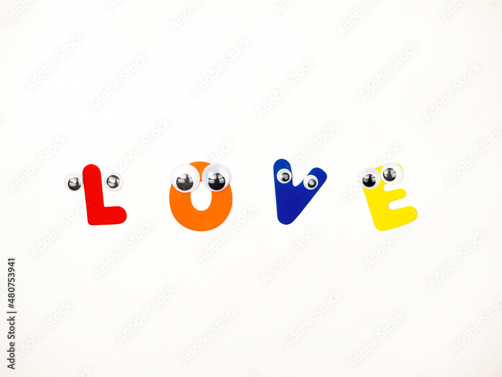 Obraz premium The word Love in Multicolored Letters with Eyes on a White Background.