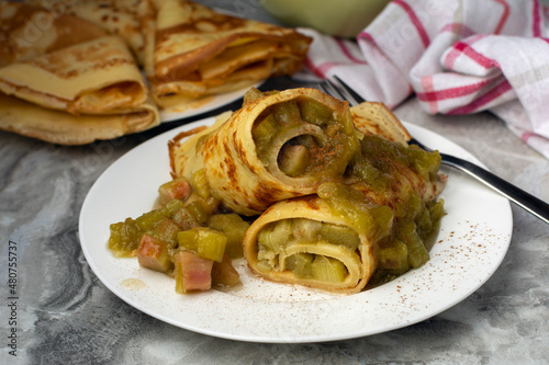 Thin German Pancakes (like French crepes) with sweet caramelized rhubarb filling, served with loads of cinnamon and sugar. The pancake is the classic from the kitchen of our childhood.