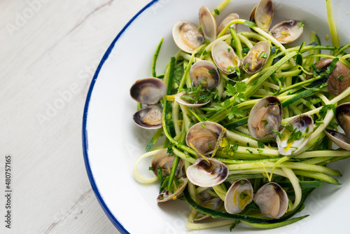 Zucchini strips with clams and lemon sauce.