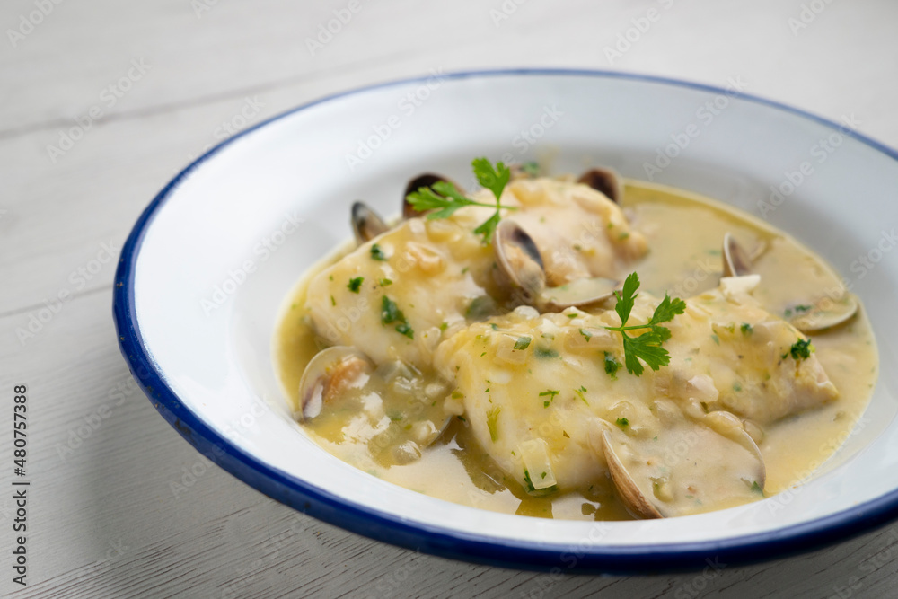 Hake in green sauce with parsley and clams. Traditional Spanish recipe. Hake in green sauce with parsley and clams. Traditional Spanish recipe.