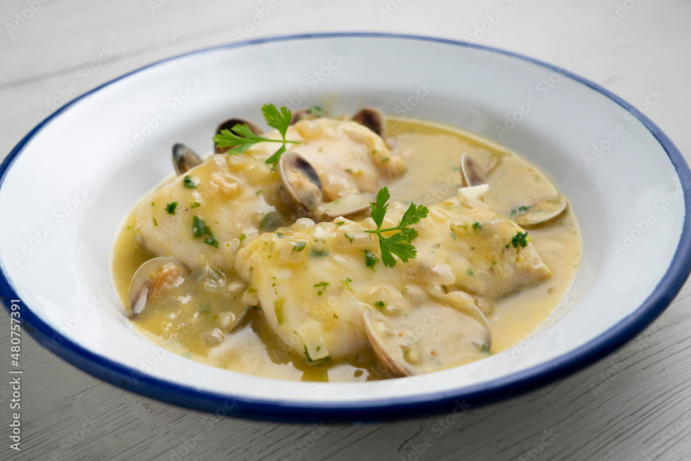 Hake in green sauce with parsley and clams. Traditional Spanish recipe.